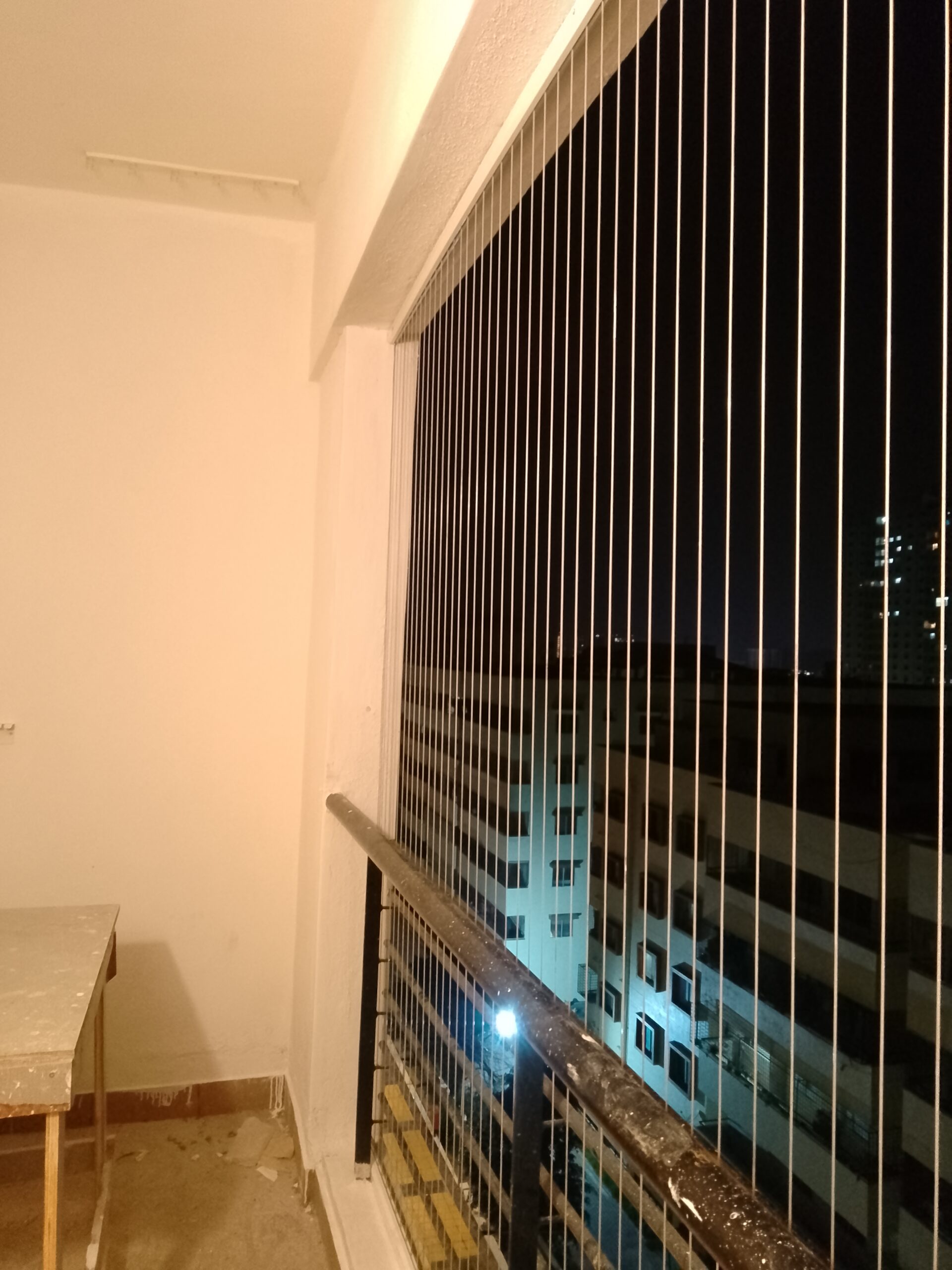 Invisible grill installed on a high-rise apartment balcony in Chennai