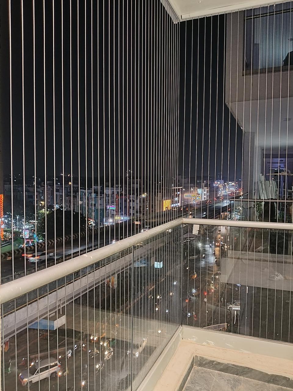 Invisible grill installed on a high-rise apartment balcony in Chennai