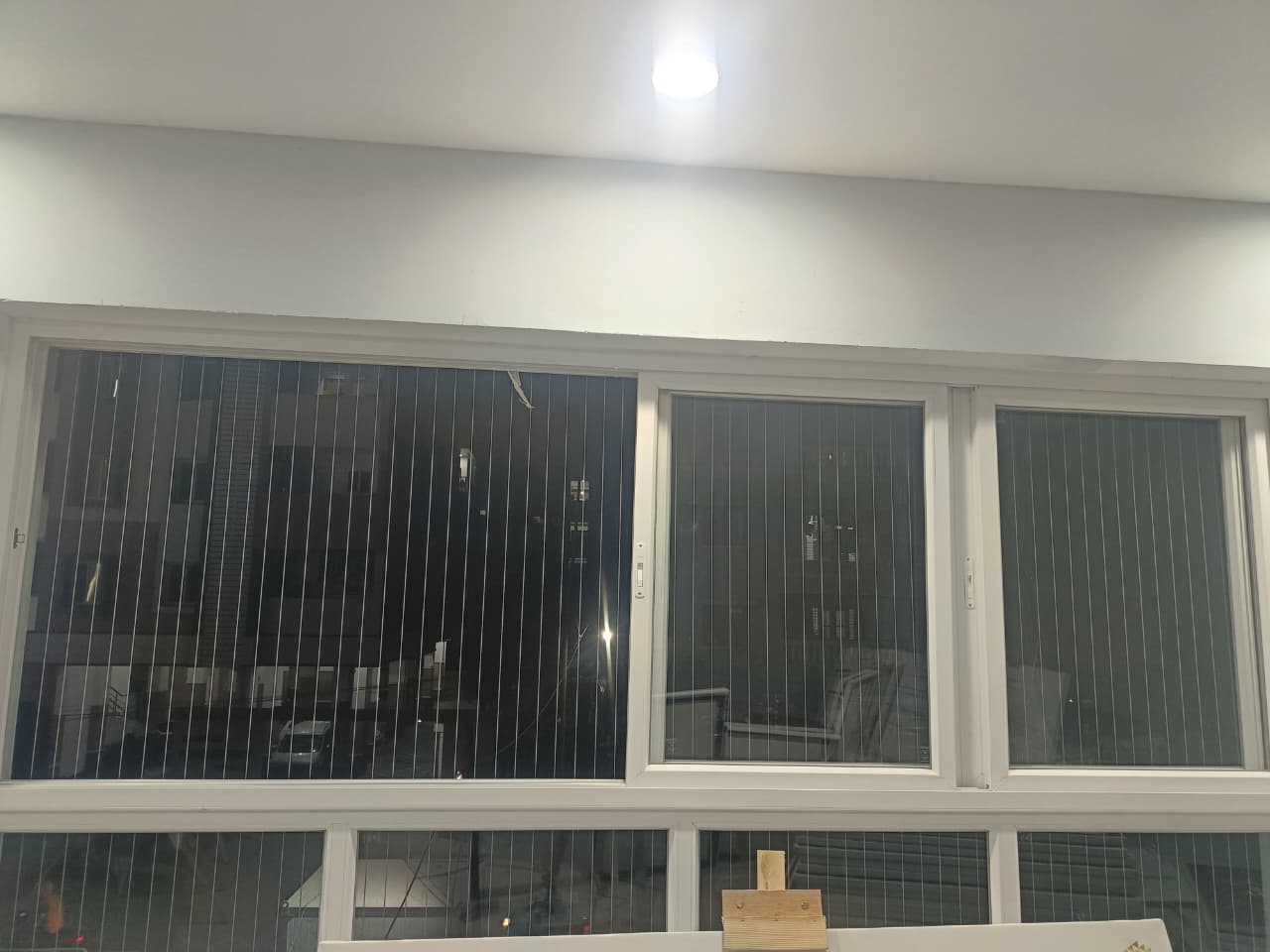 Invisible grill installed on a window in a Chennai home